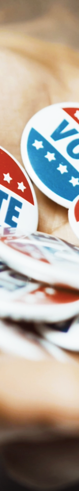 Man's hand full of "Vote" buttons